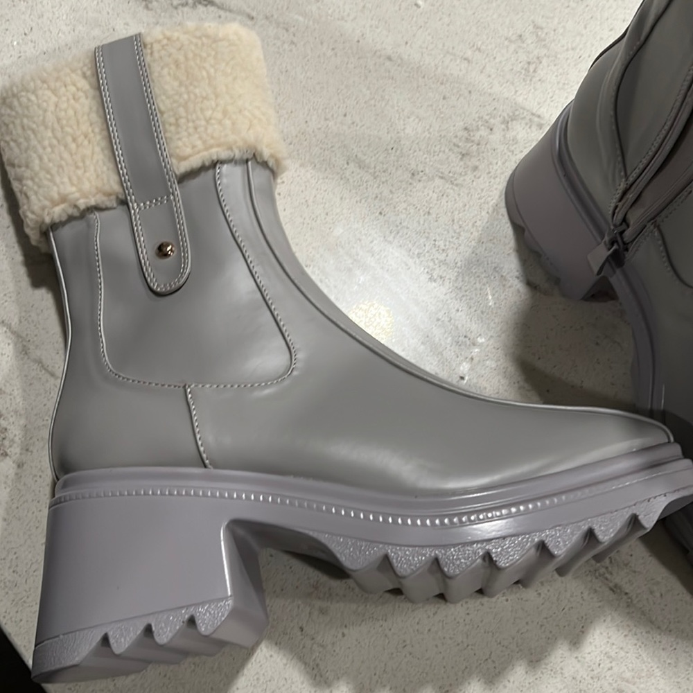 Brand new Women’s weather boot with rubber sole.